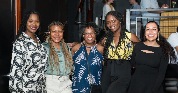 Smiling group of doctoral degree candidates at a reception